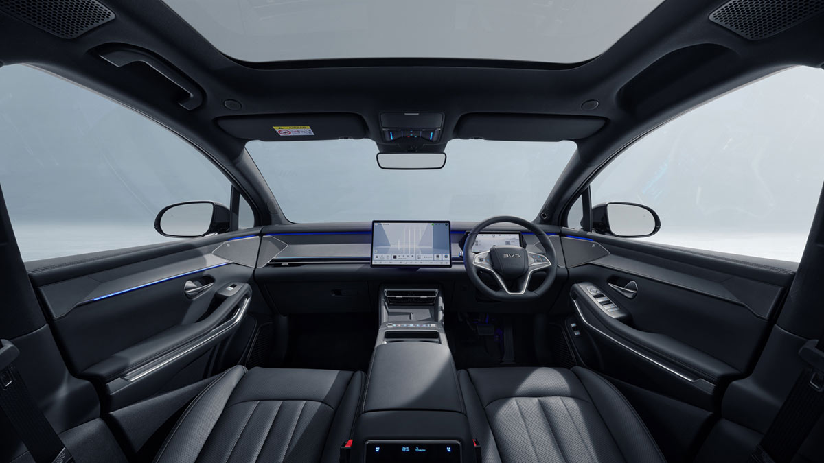 The front seats of a BYD Sealion 8, showing black leather seats and a central touchscreen.